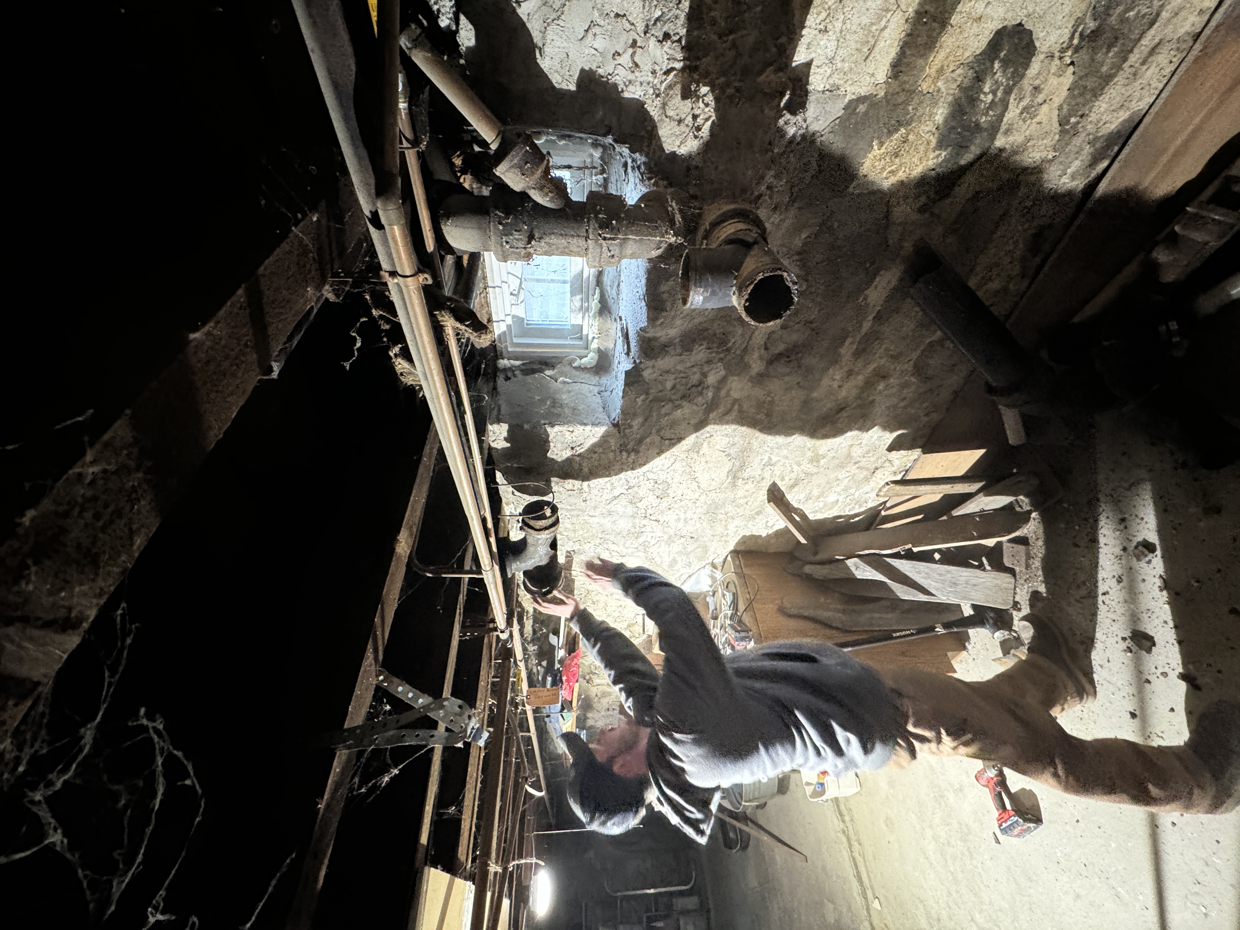 Active drain repair in stone foundation basement